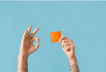 10 Reasons must Use Condoms shown with hands holding an orange condom against a blue background.
