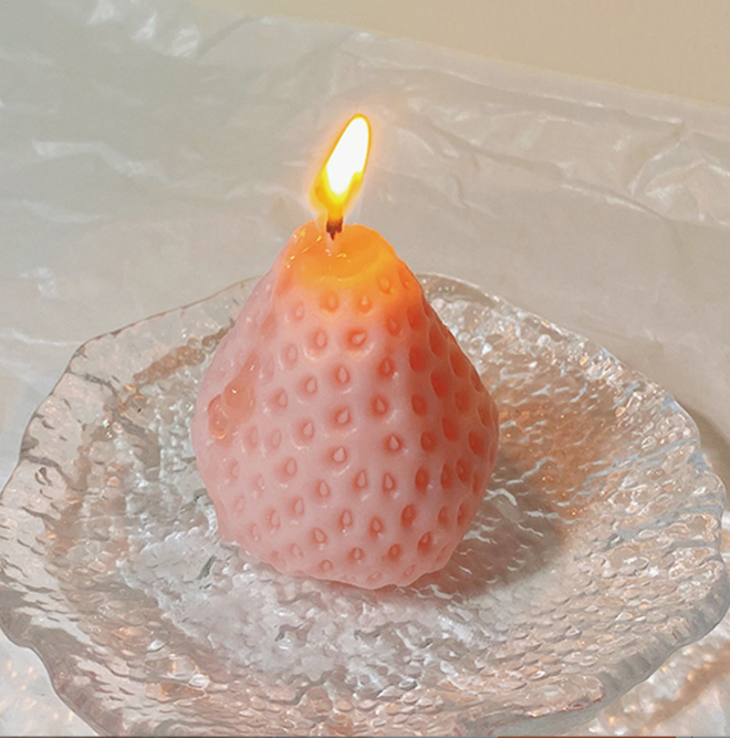 Strawberry Low Temp Candle burning on a glass plate, ideal for couples beginners' wax play.