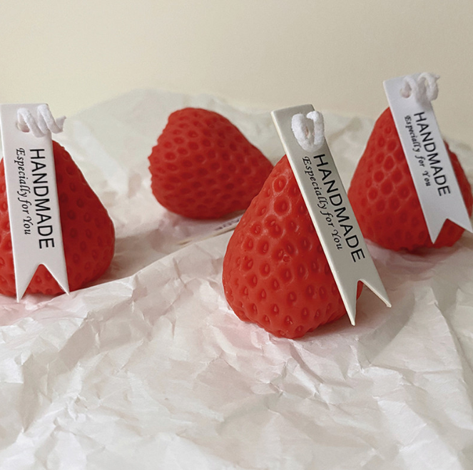 Strawberry Low Temp Candle burning on a glass plate, ideal for couples beginners' wax play.