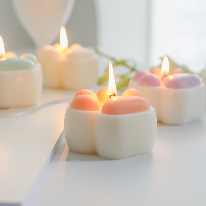 Low Temperature BDSM Cat Claw Candle glowing softly with colorful wax tops, perfect for intimate wax play.