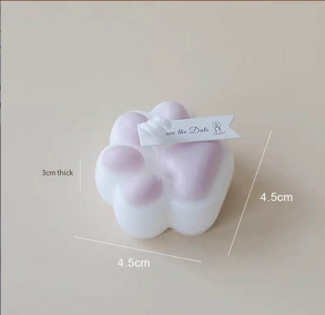 Low Temperature BDSM Cat Claw Candle in white and pink, measures 4.5cm by 4.5cm with a 3cm thickness.