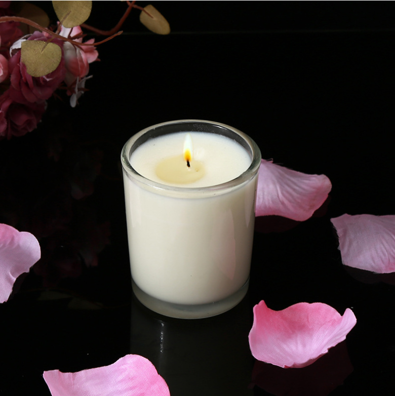 Aromatherapy Massage Candle for sex, coconut wax, smokeless candle surrounded by rose petals.
